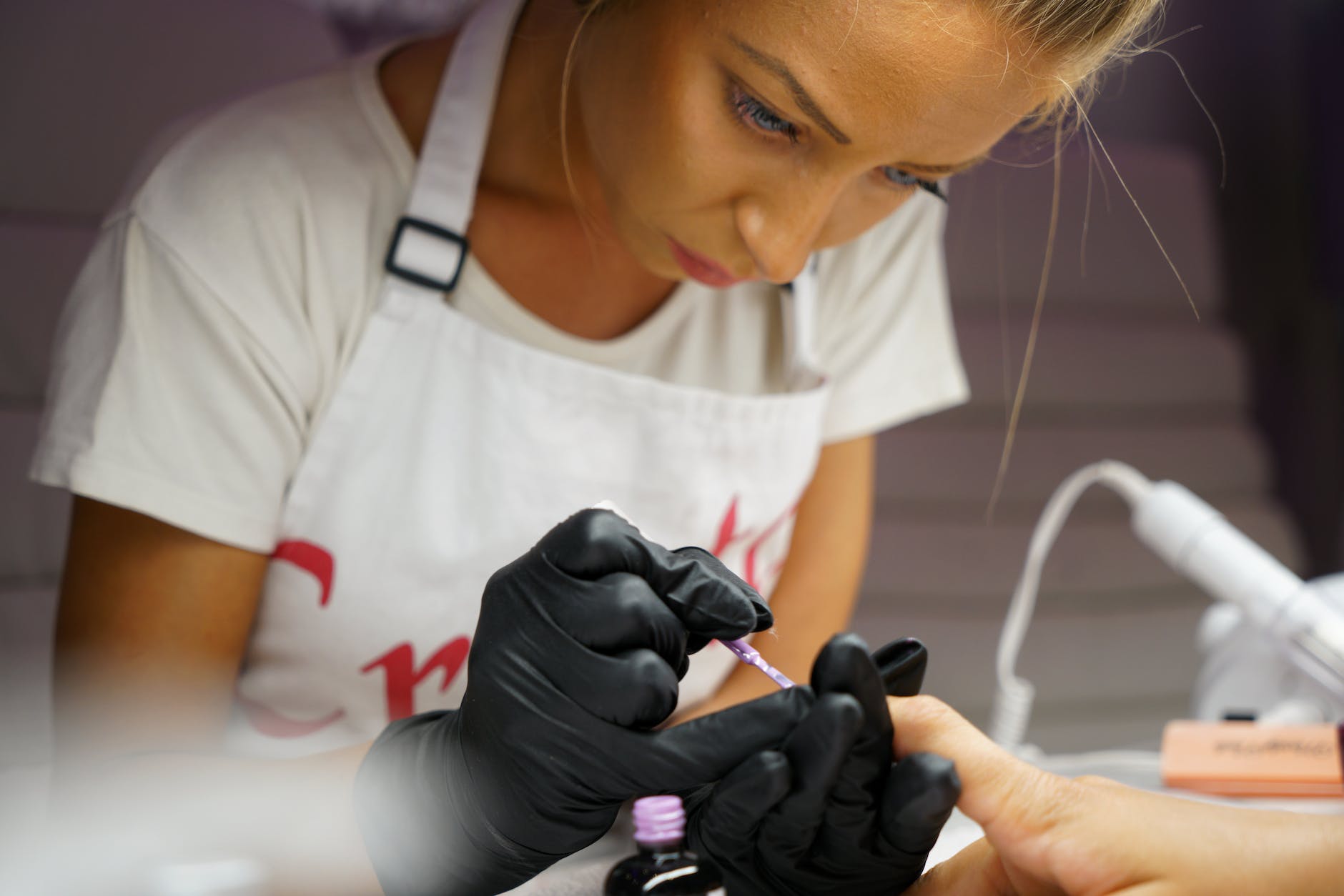 selective focus photography of woman manicuring person